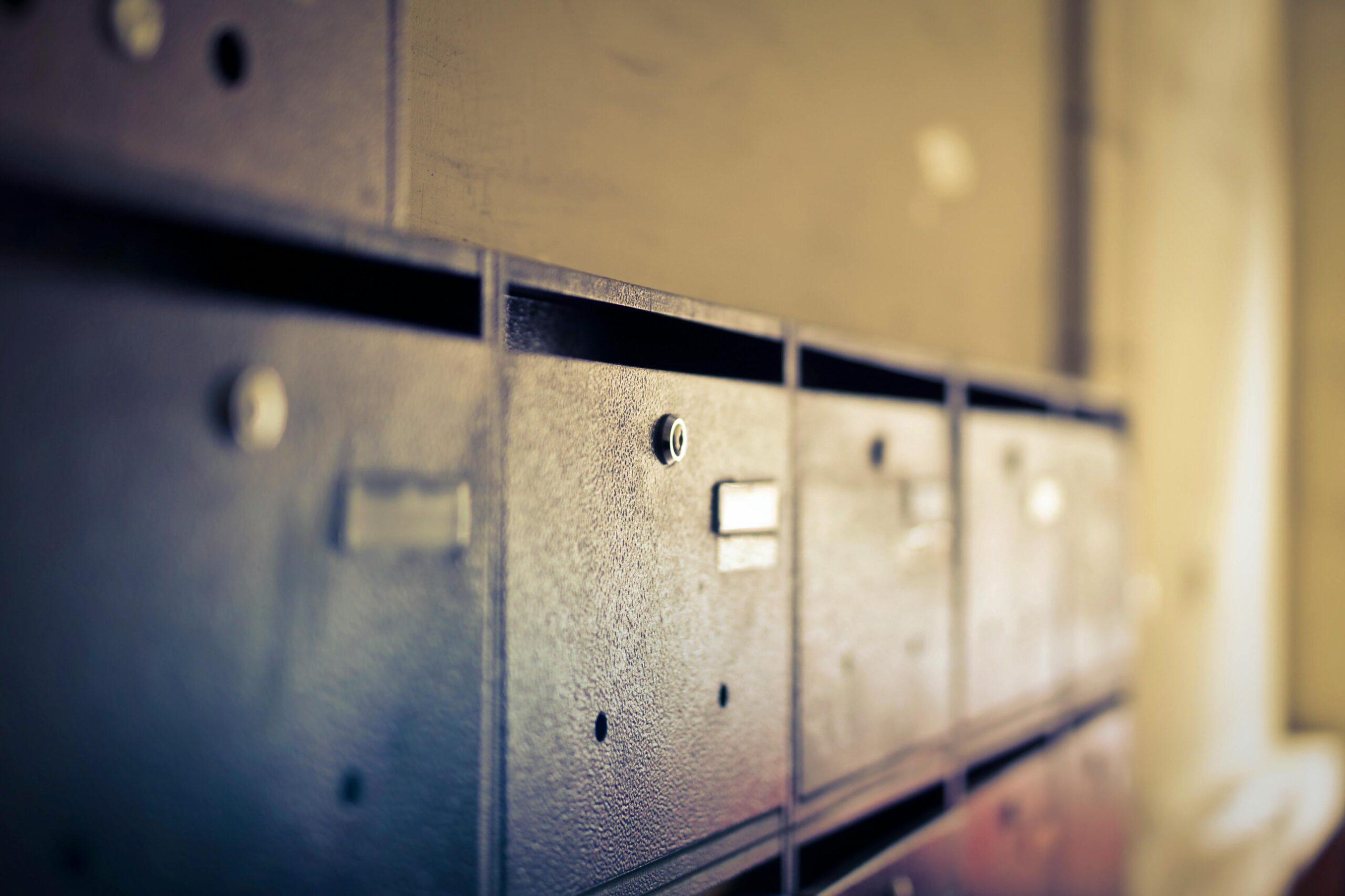 A close-up shot of vintage metal mailboxes indoors with a soft blur effect.